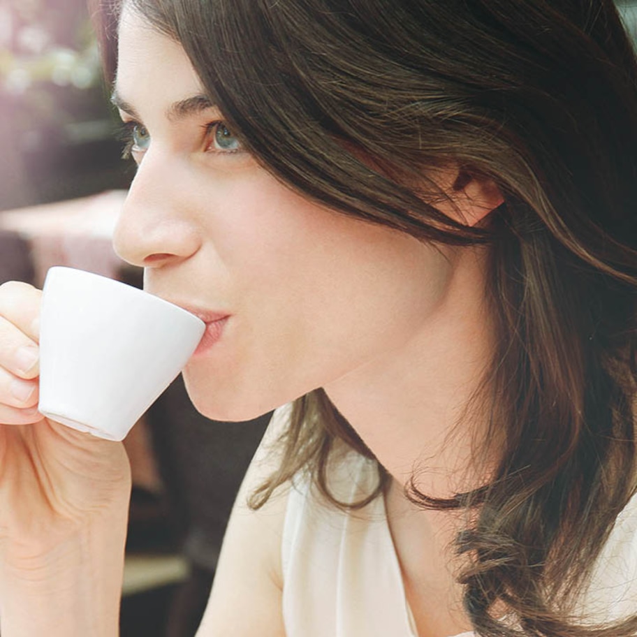 Franke Coffee Systems woman drinking espresso, white cup